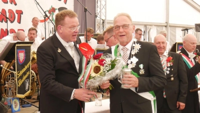 Bürgerschützenkönig Rolf Thal (re.) erhält die Schützenkette vom Komitee-Ältesten Frank Döpke. (Foto: gk)